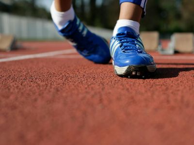 Close-up of running shoes on a clean floor, ready for action.