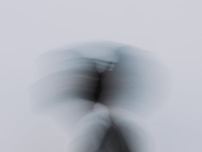 Person in motion against a minimalist background, conveying fluidity.